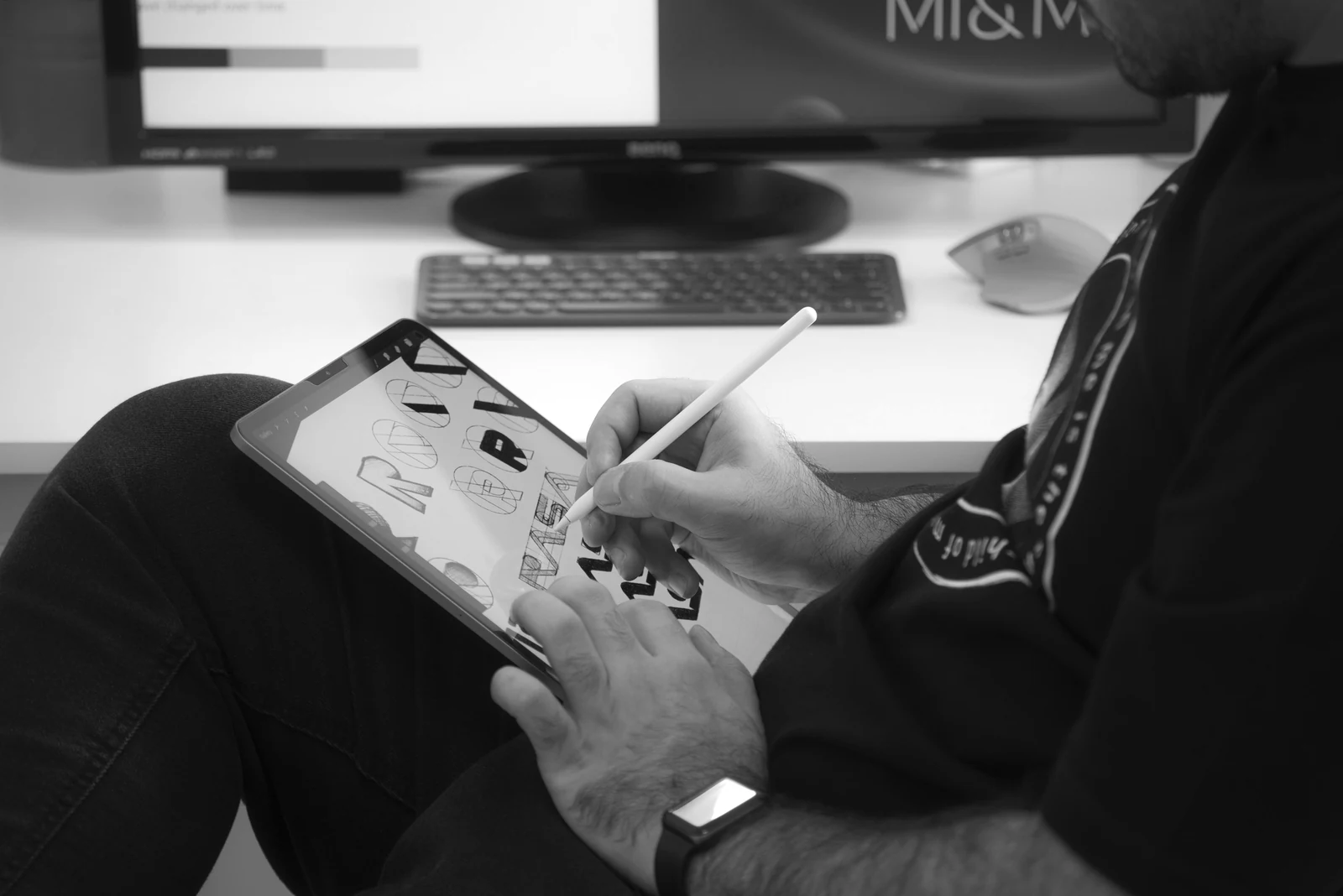 person in black jacket holding white printer paper. Photograph accompanying Velaharra’s artist career strategy guide.