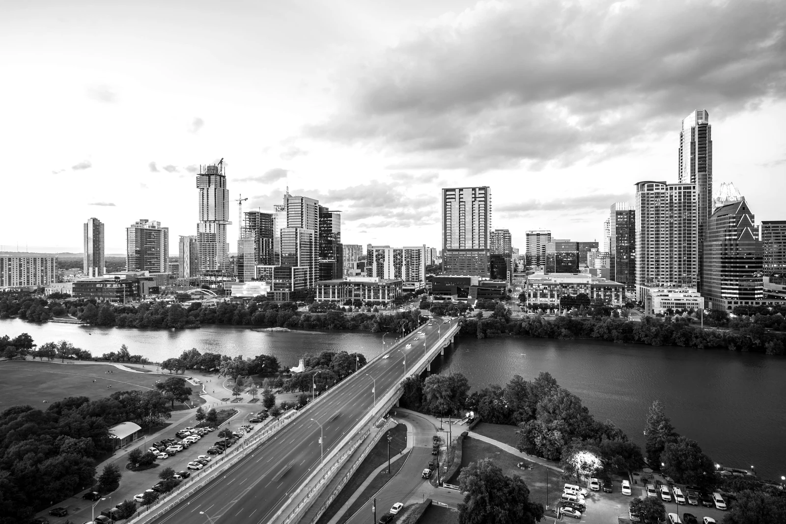 An aerial view of the Austin skyline and Congress Avenue Bridge over Lady Bird Lake. Photograph accompanying Velaharra’s creative community Austin guide.