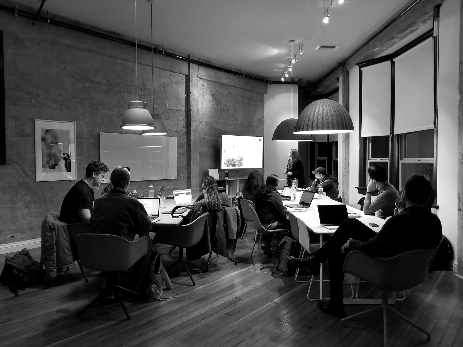 people sitting and using laptops. Photograph accompanying Velaharra’s measuring cultural impact guide.