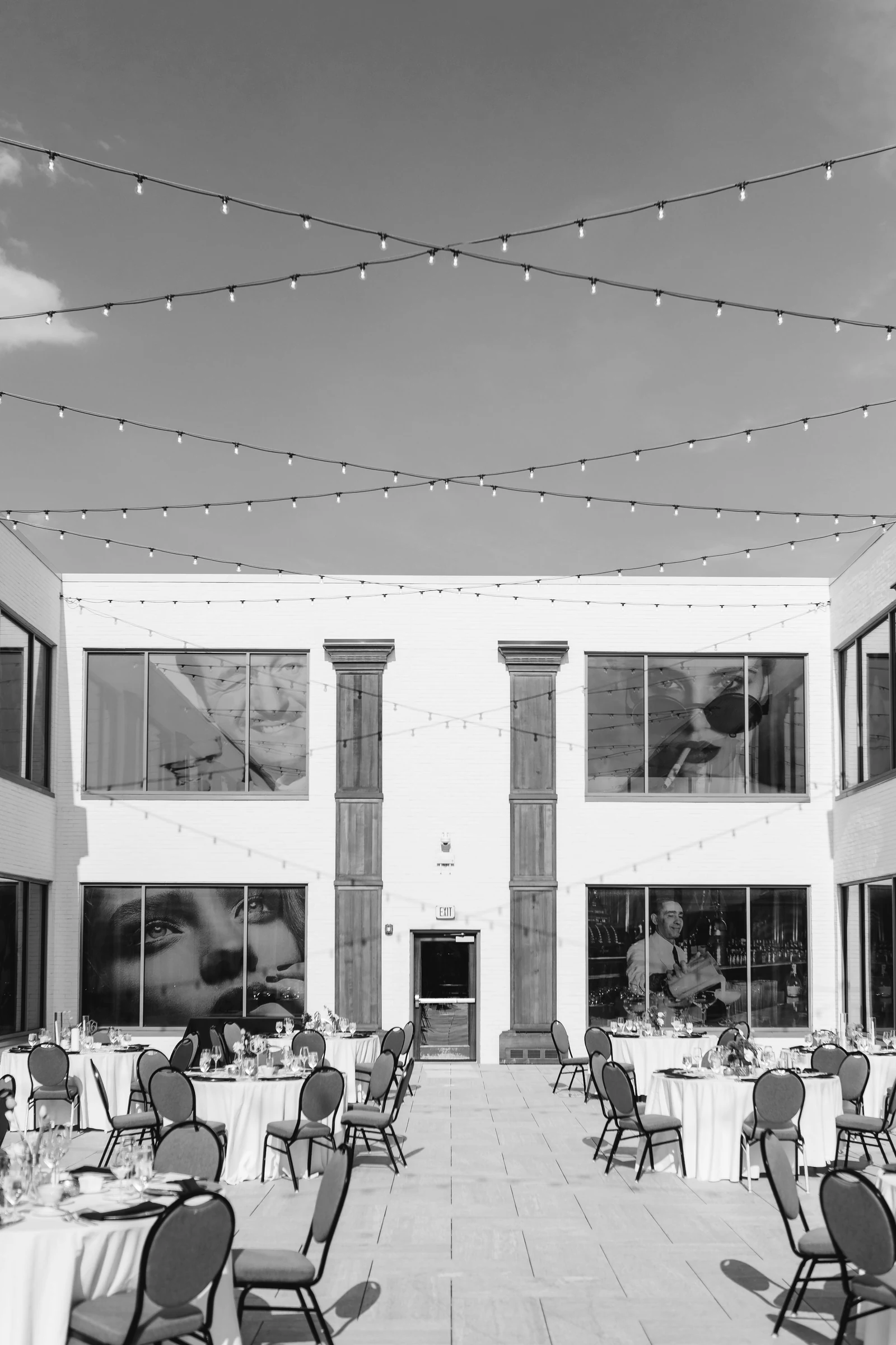 a large white building with tables and chairs. Photograph accompanying Velaharra’s cultural programming for hotels guide.