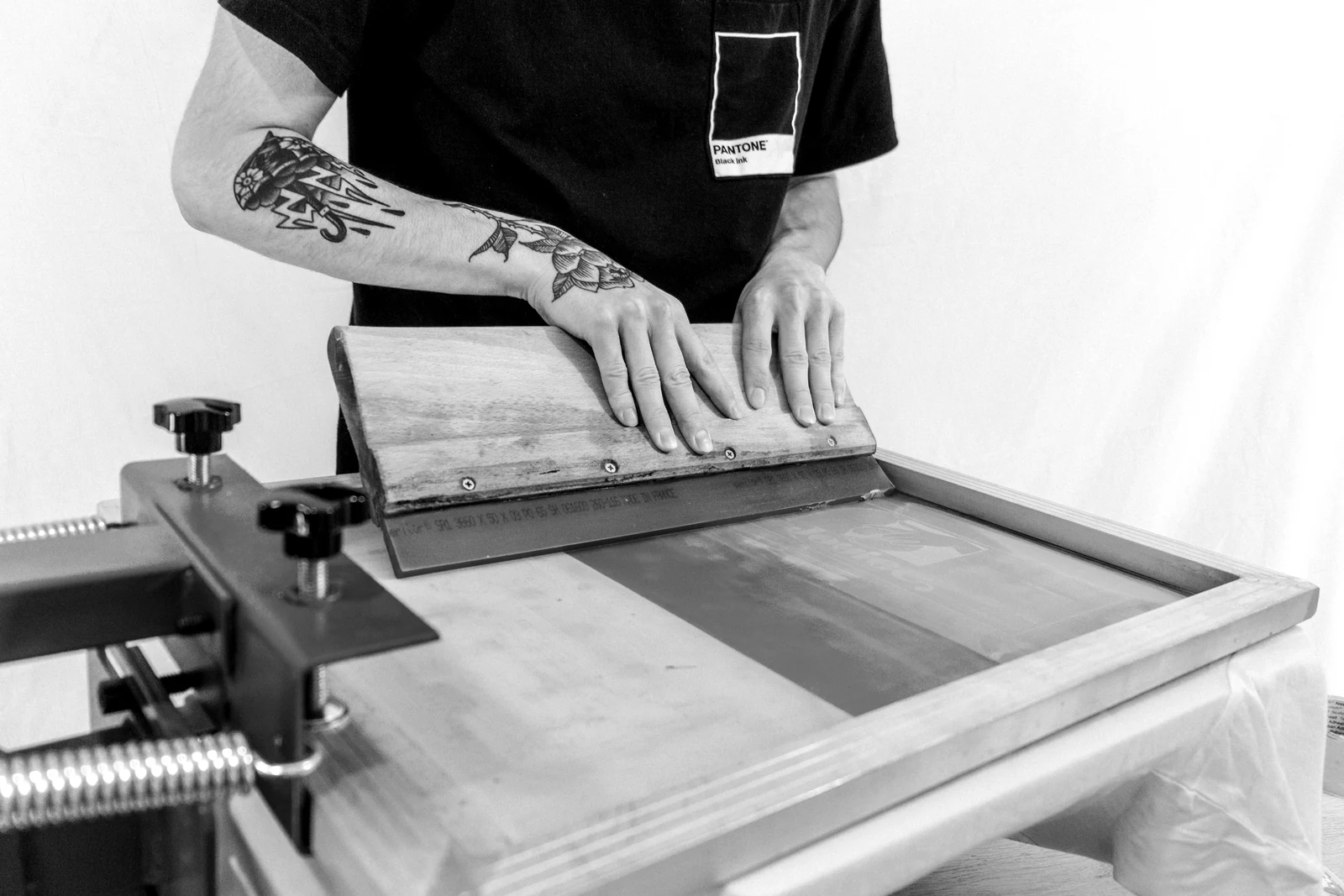 person in black t-shirt holding brown wooden board. Photograph accompanying Velaharra’s brand collaborations for artists guide.